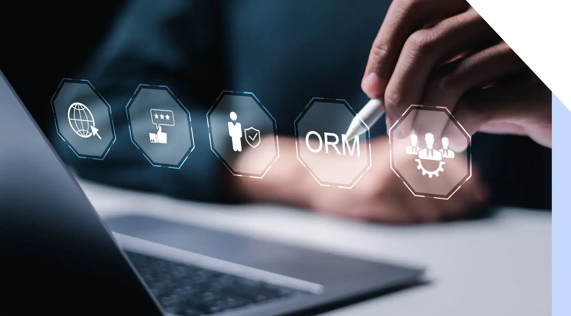 A person using a stylus to interact with digital ORM and marketing icons above a laptop