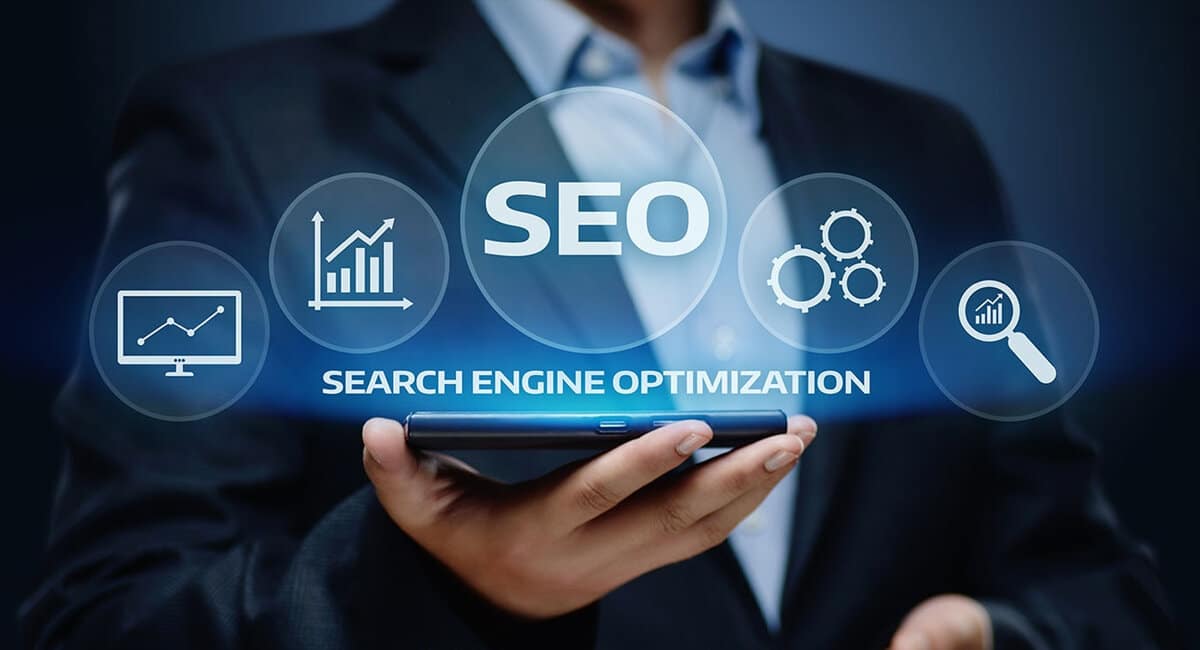 a person holding a smartphone with SEO-related icons around it