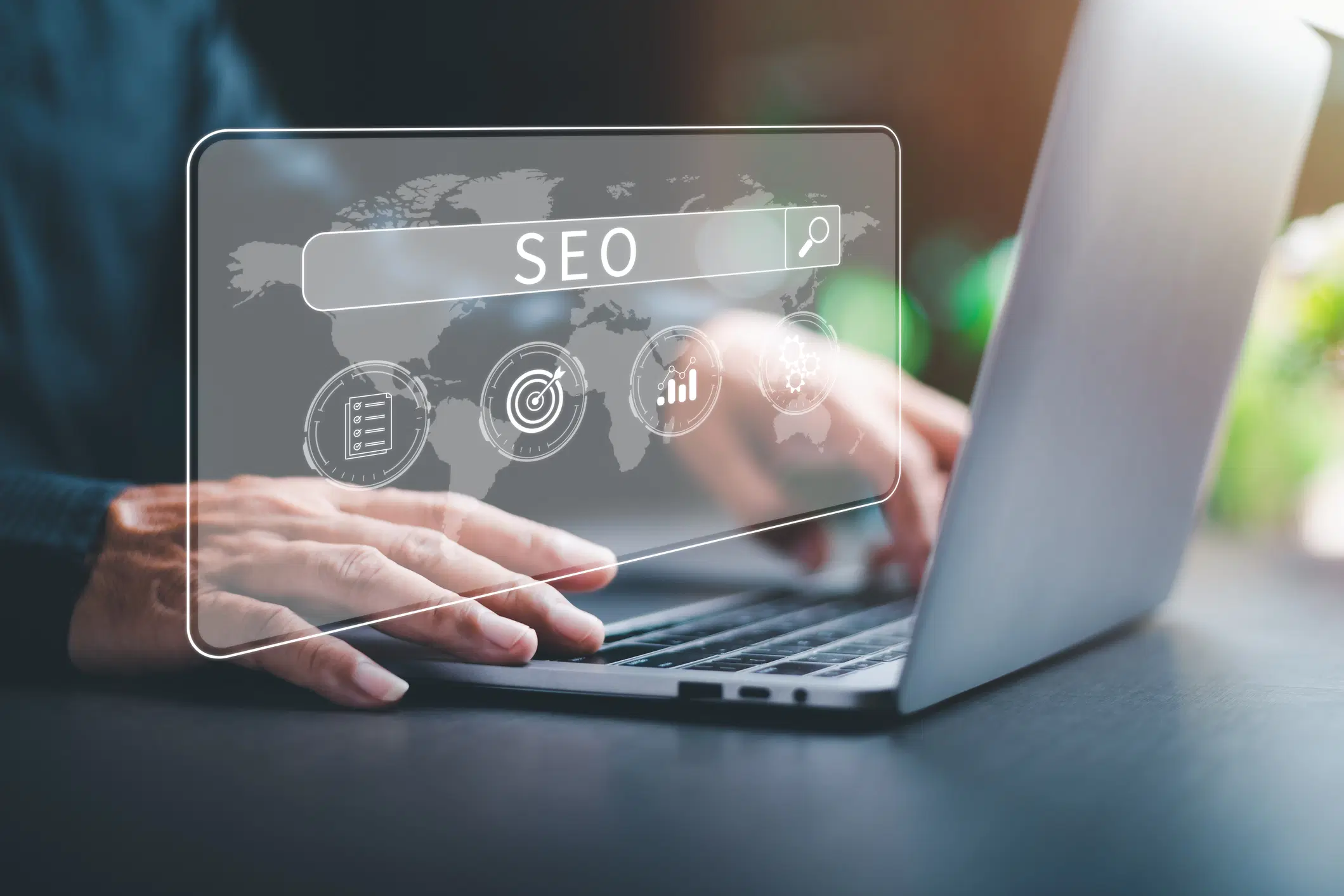 a person typing on a laptop with SEO-related icons overlaid.