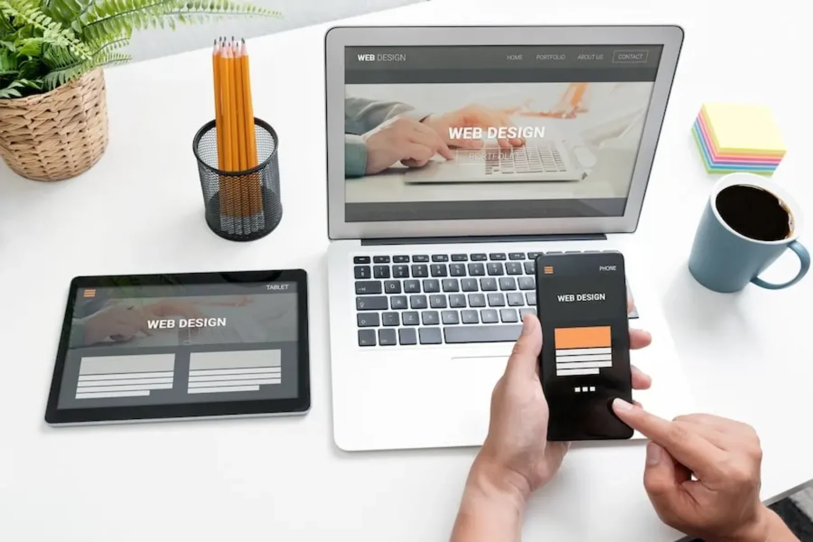 Web design displayed on mobile, tablet, and laptop