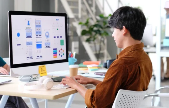 an asian UI UX designer working on a design