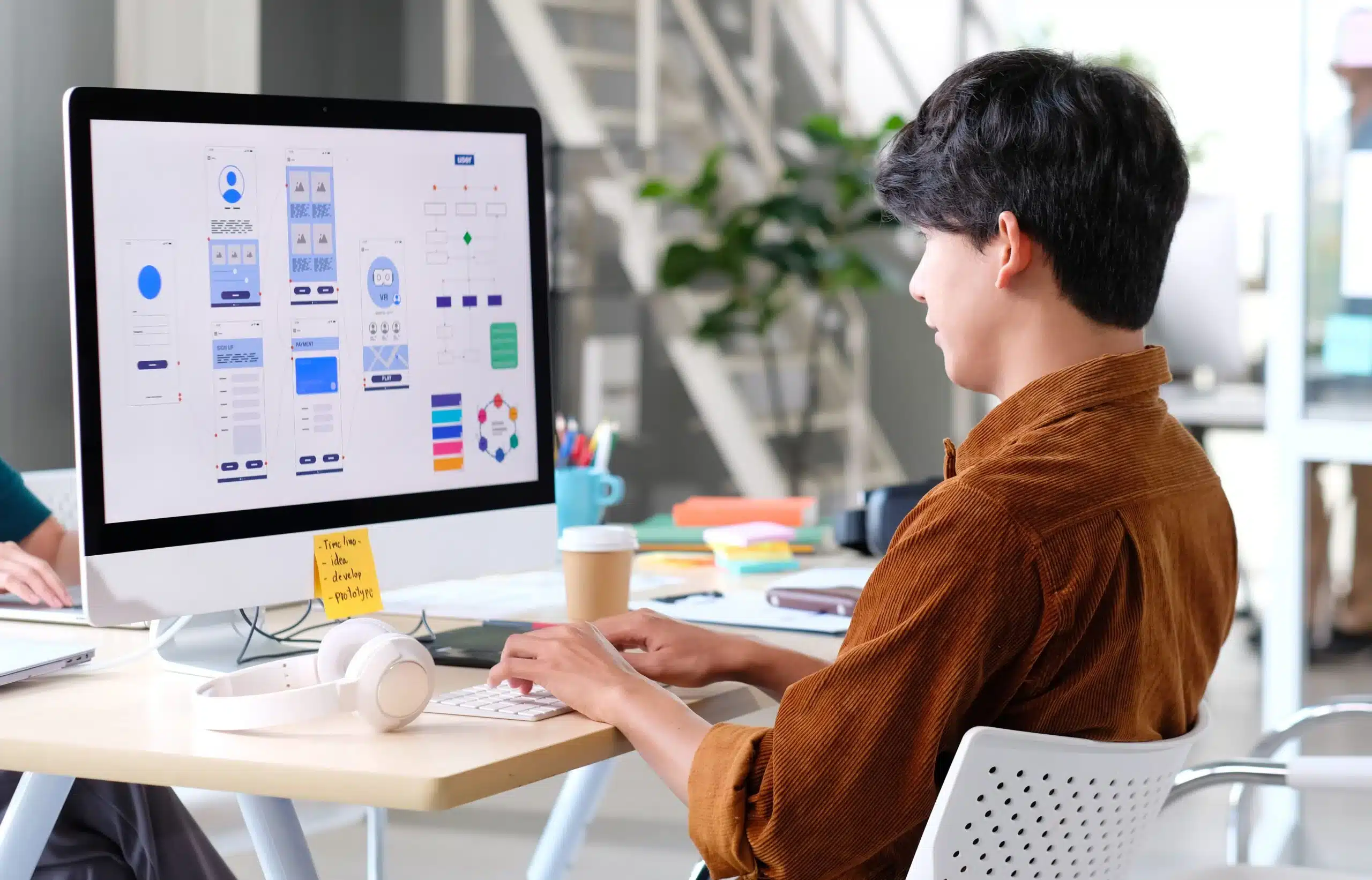 an asian UI UX designer working on a design