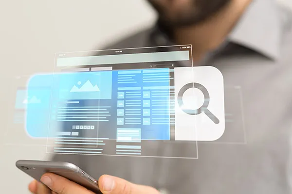 A person holding a smartphone with a digital interface showing website elements and a magnifying glass icon. (2)