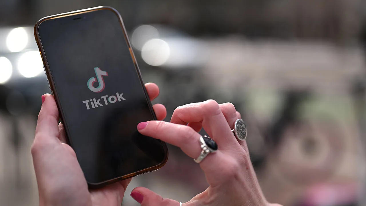 close up of a girl using TikTok on her phone