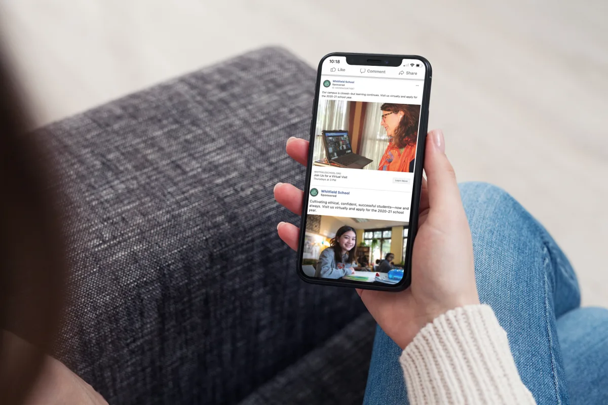 zoom in view of a hand using phone, social media ads on screen