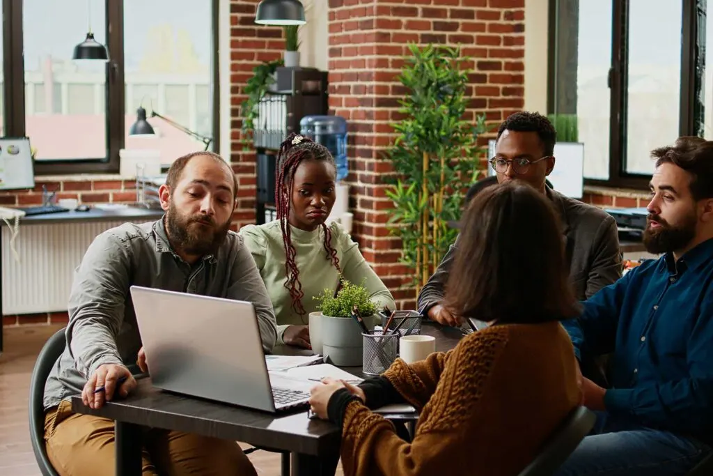 a group of social media experts discussing ROI in a room