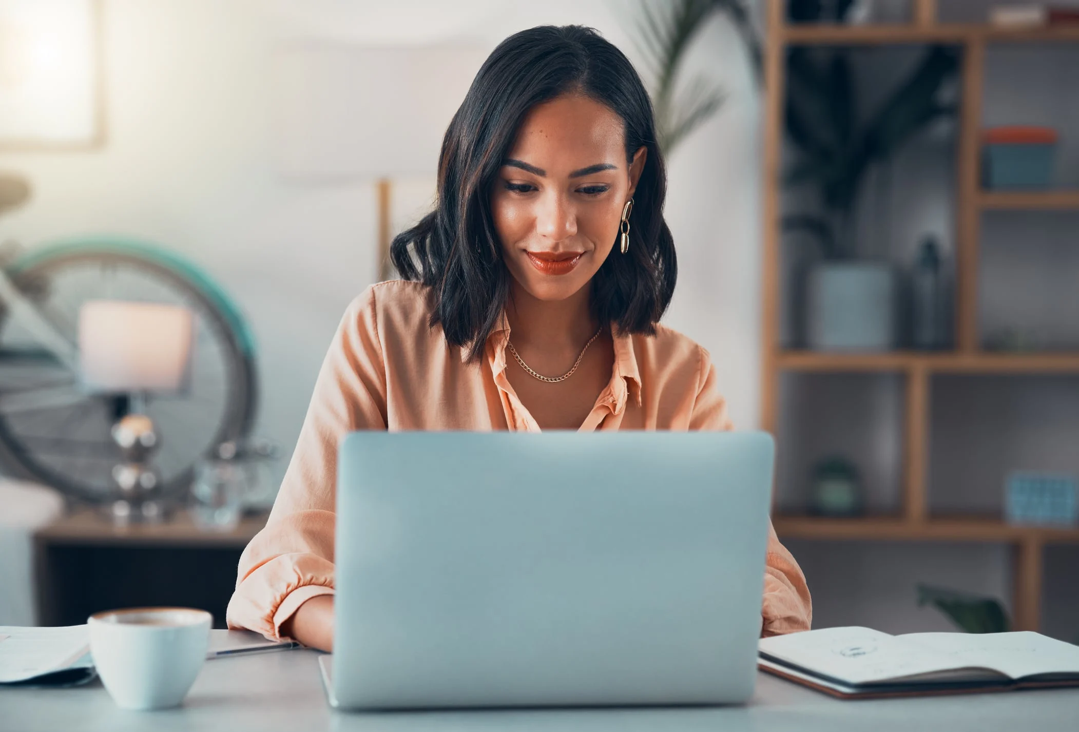 a lady in corporate getup working on a laptop
