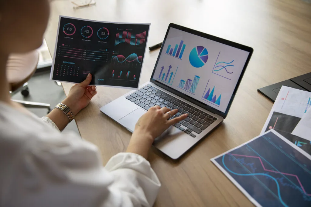 view of hands using laptop to track growth of a social campaign