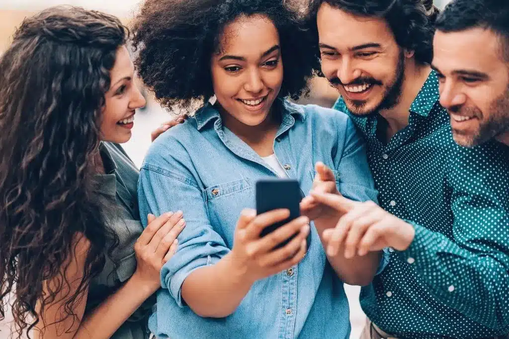 Group of people engaging with content on a smartphone.
