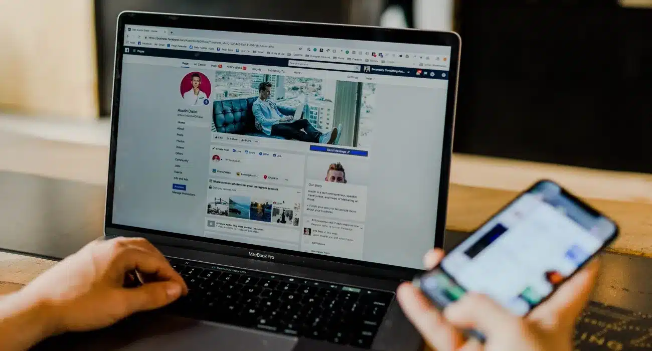 Laptop and smartphone displaying social media pages.