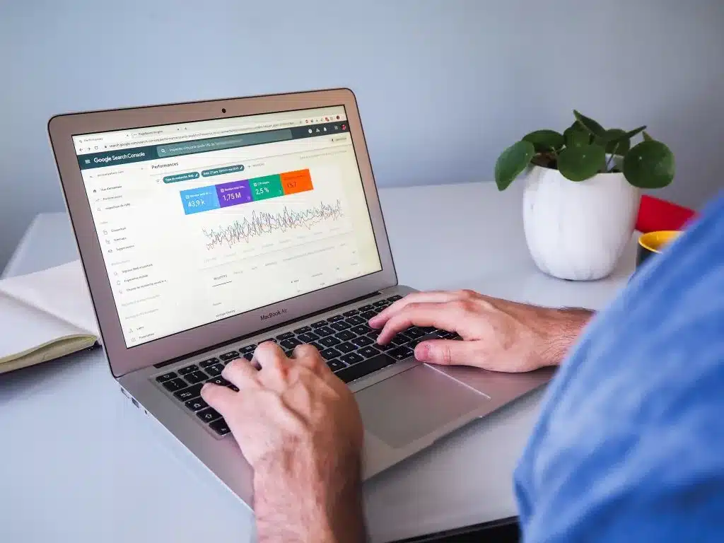 Person viewing Google Search Console analytics dashboard on a laptop.