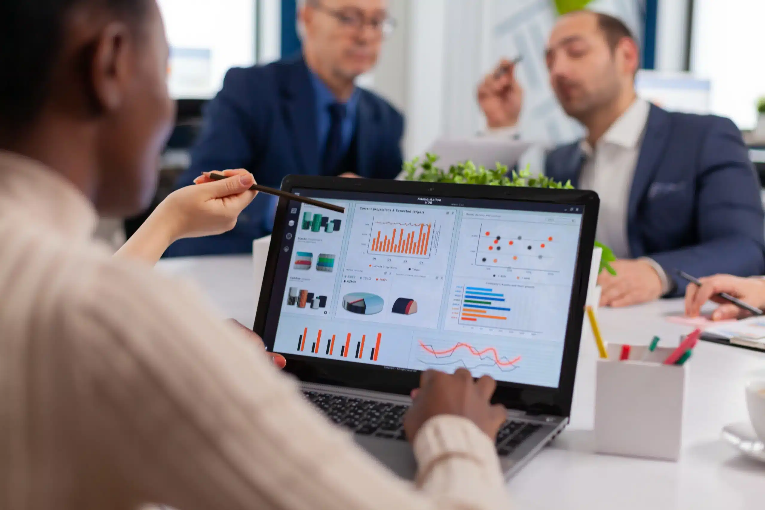 Team analyzing business analytics data on a laptop dashboard.
