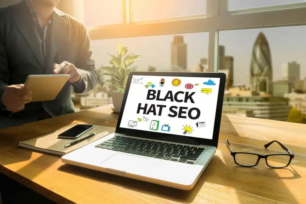 Laptop displaying “Black Hat SEO” concept on a desk