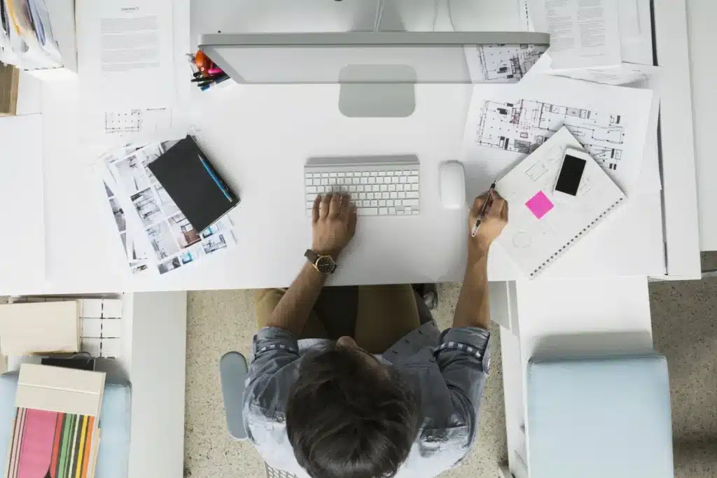 Person working on website design at a modern computer workspace having all benefits of website development
